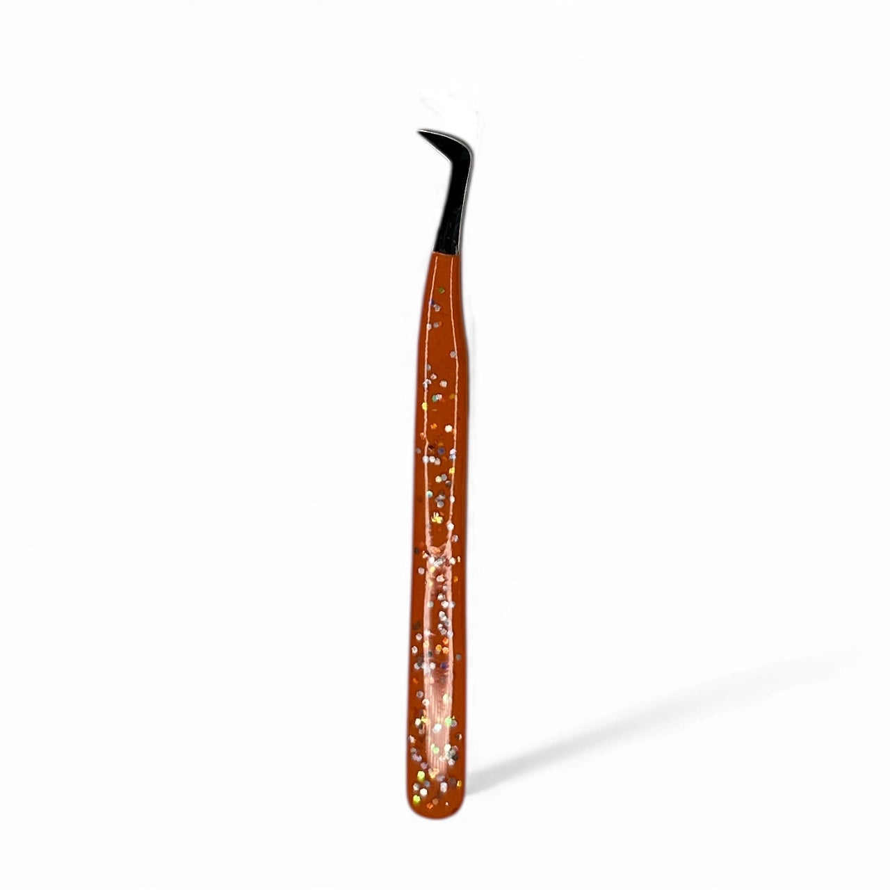 Orange glitter tweezers with a black tip on a white background