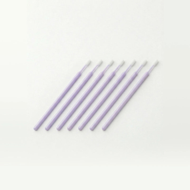 Set of lavender colored microswabs on a white background