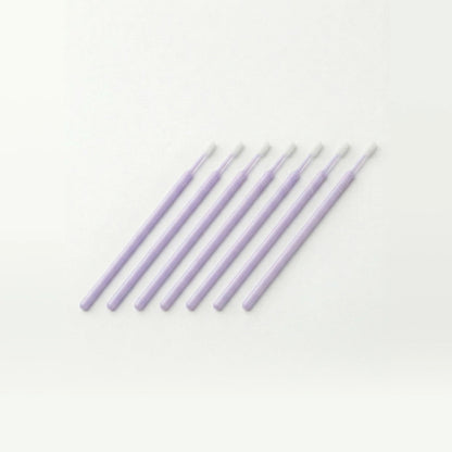 Set of lavender colored microswabs on a white background