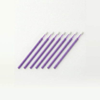 Set of purple microswabs on a white background